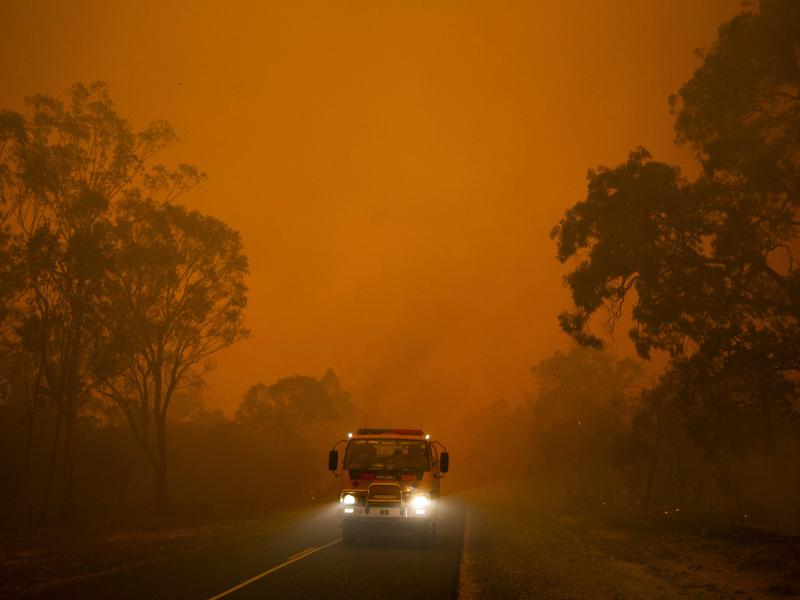 Fire truck driving near fire