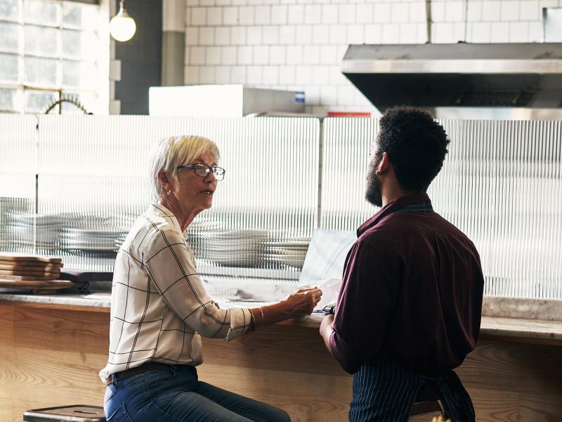 Man and woman talking in pizza restaurant